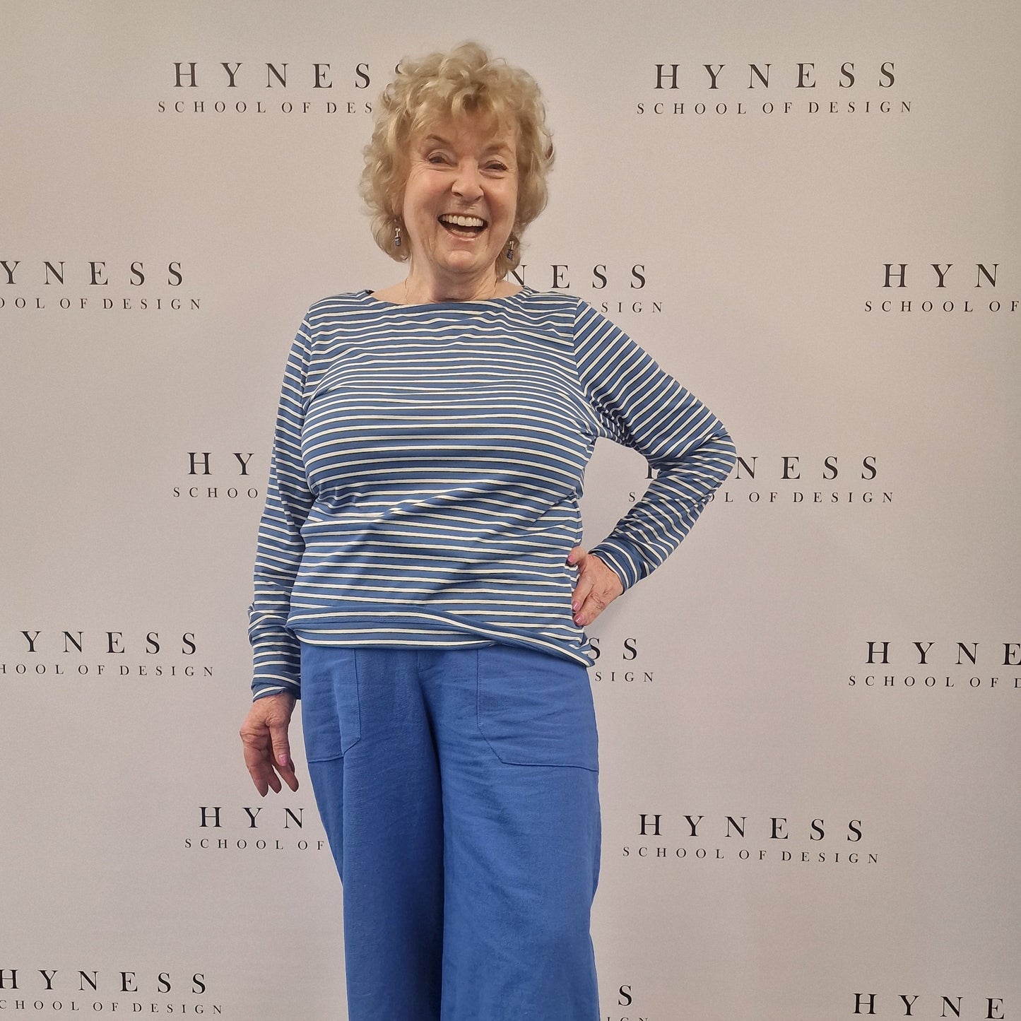 Person standing on a large Hyness poster