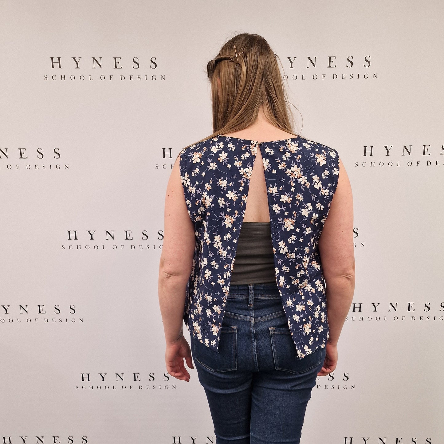 Person standing on a large book with 'Hynes' text