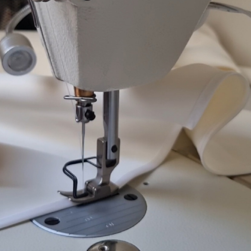 Sewing machine in action with fabric under the needle